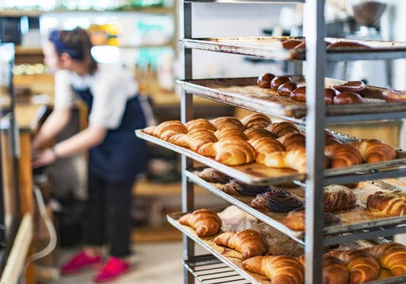 Fresh croissant cooling rack in pastry factory